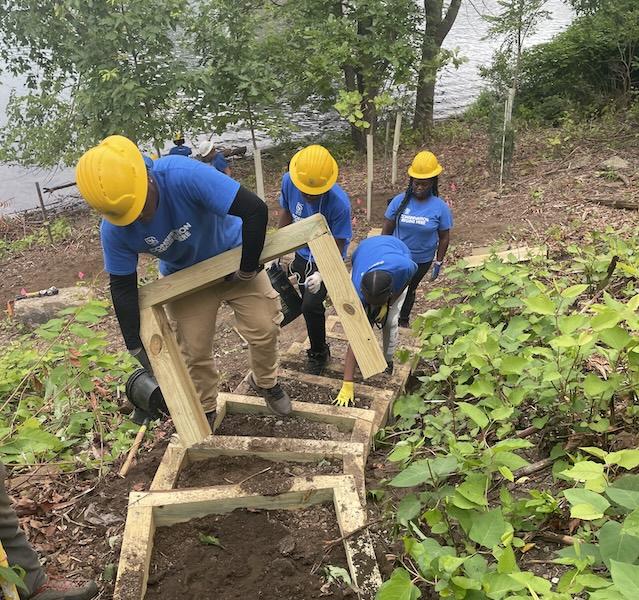 SCA Team members working on steps in a park.