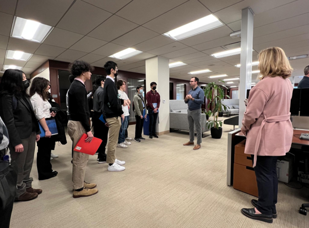 Person speaking with a group of students