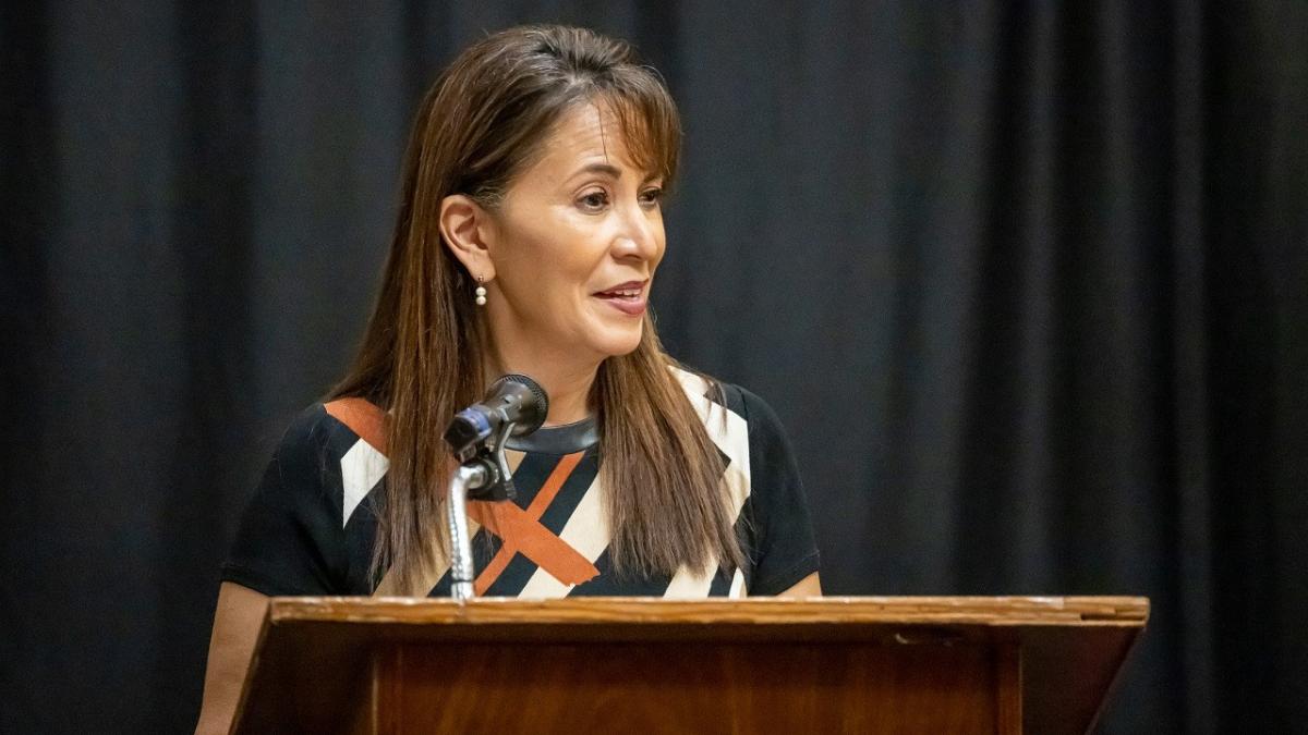 Woman speaking at a lectern