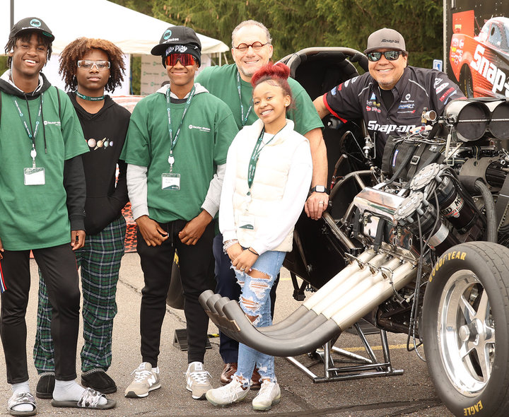 Students pose with Cruz Pedregon and his 'Nitro Funny Car'