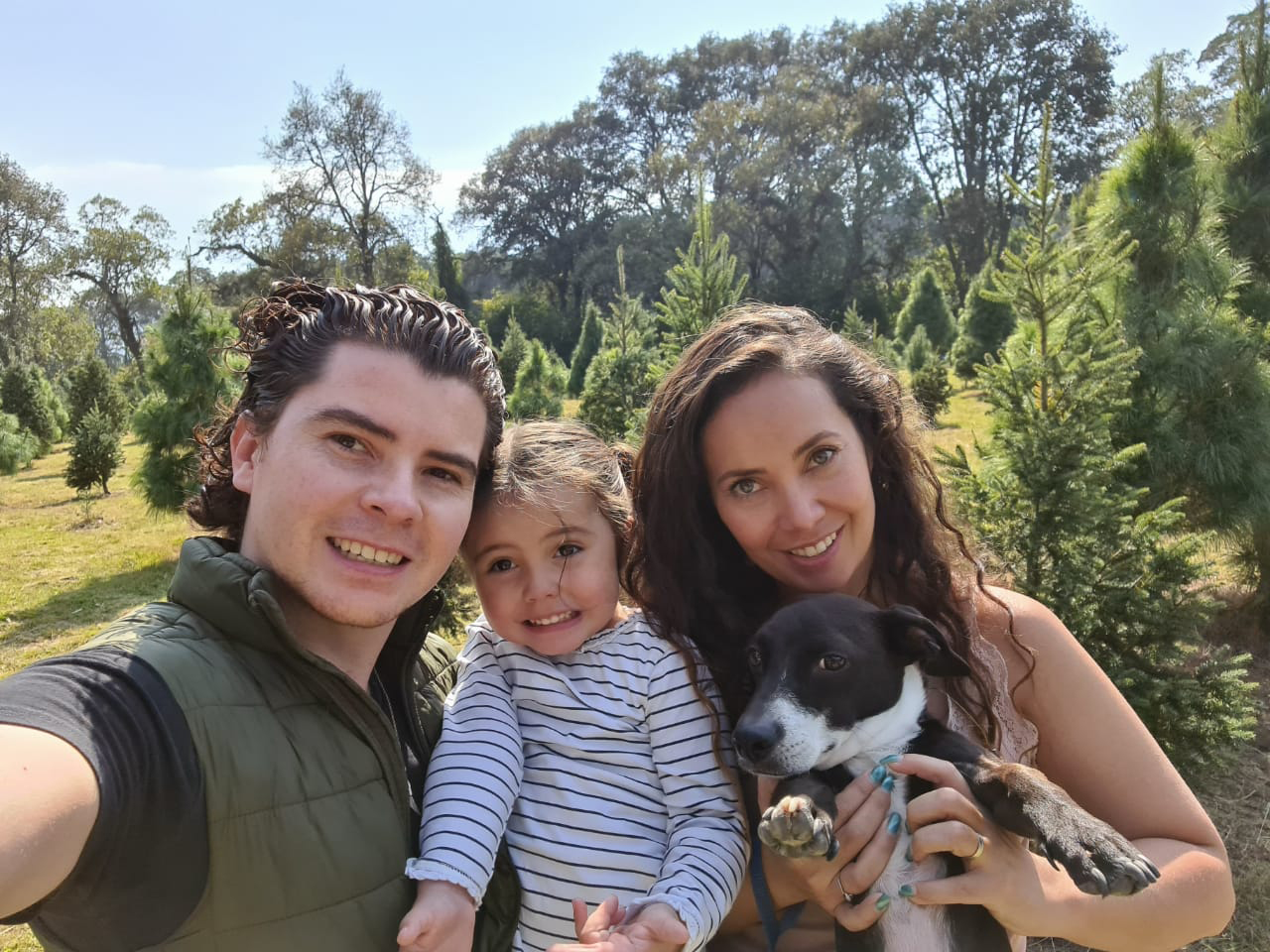 Man and woman holding daughter and dog