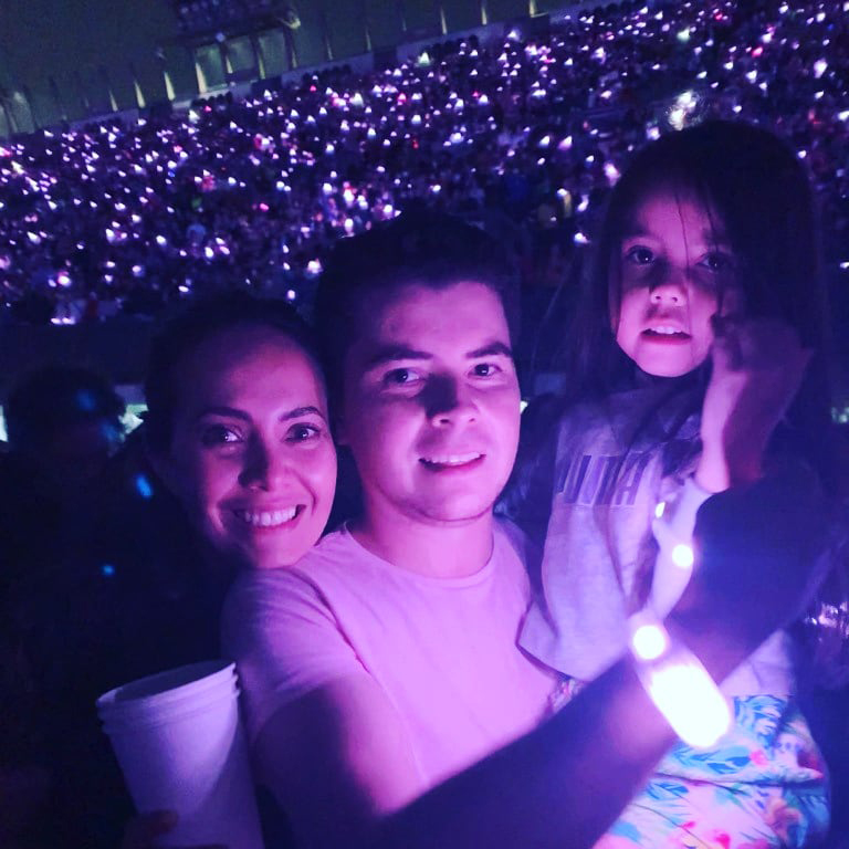 Woman, man, and daughter in a crowd