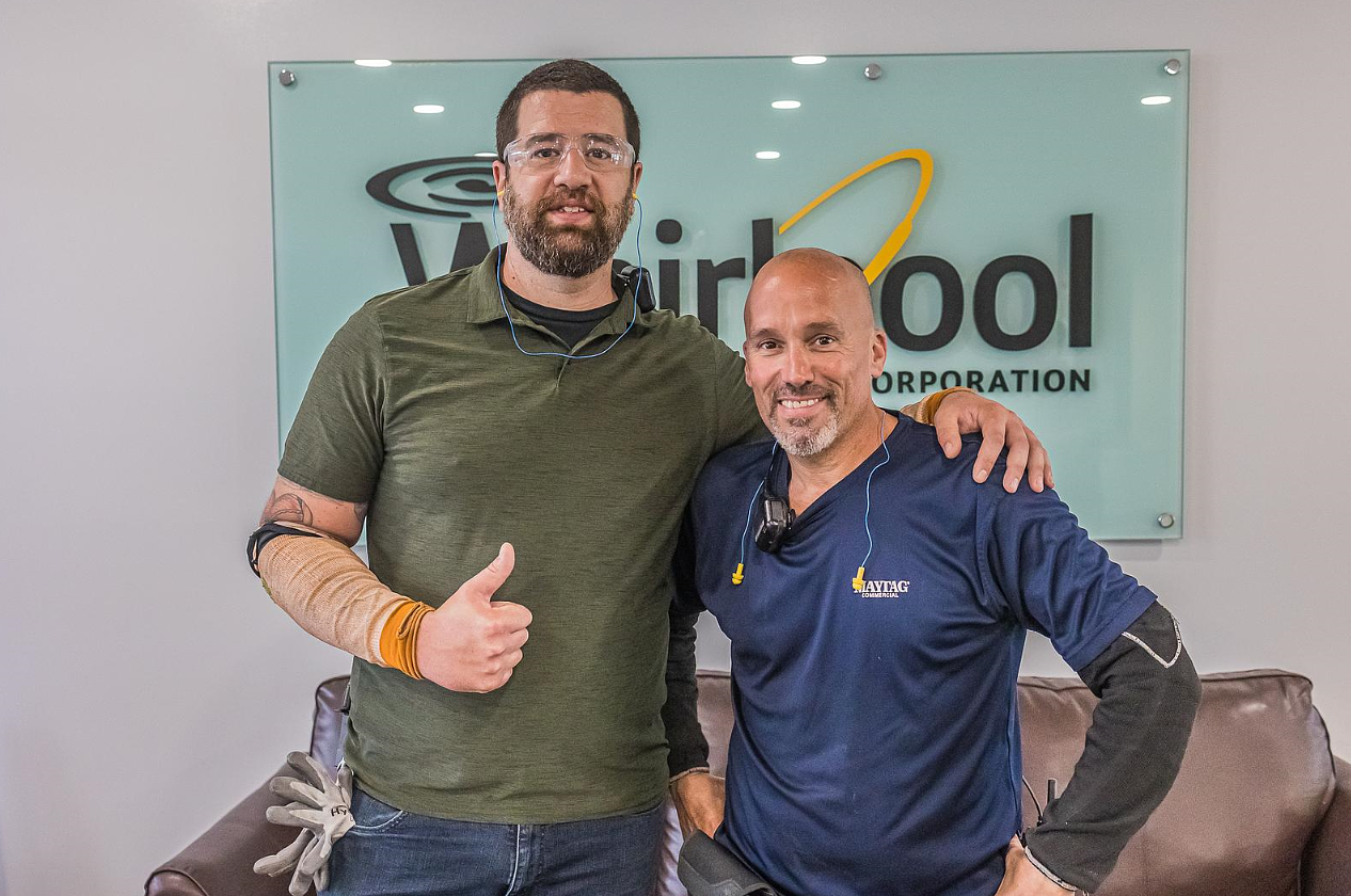 Scott Cabral and co worker in front of a whirlpool sign