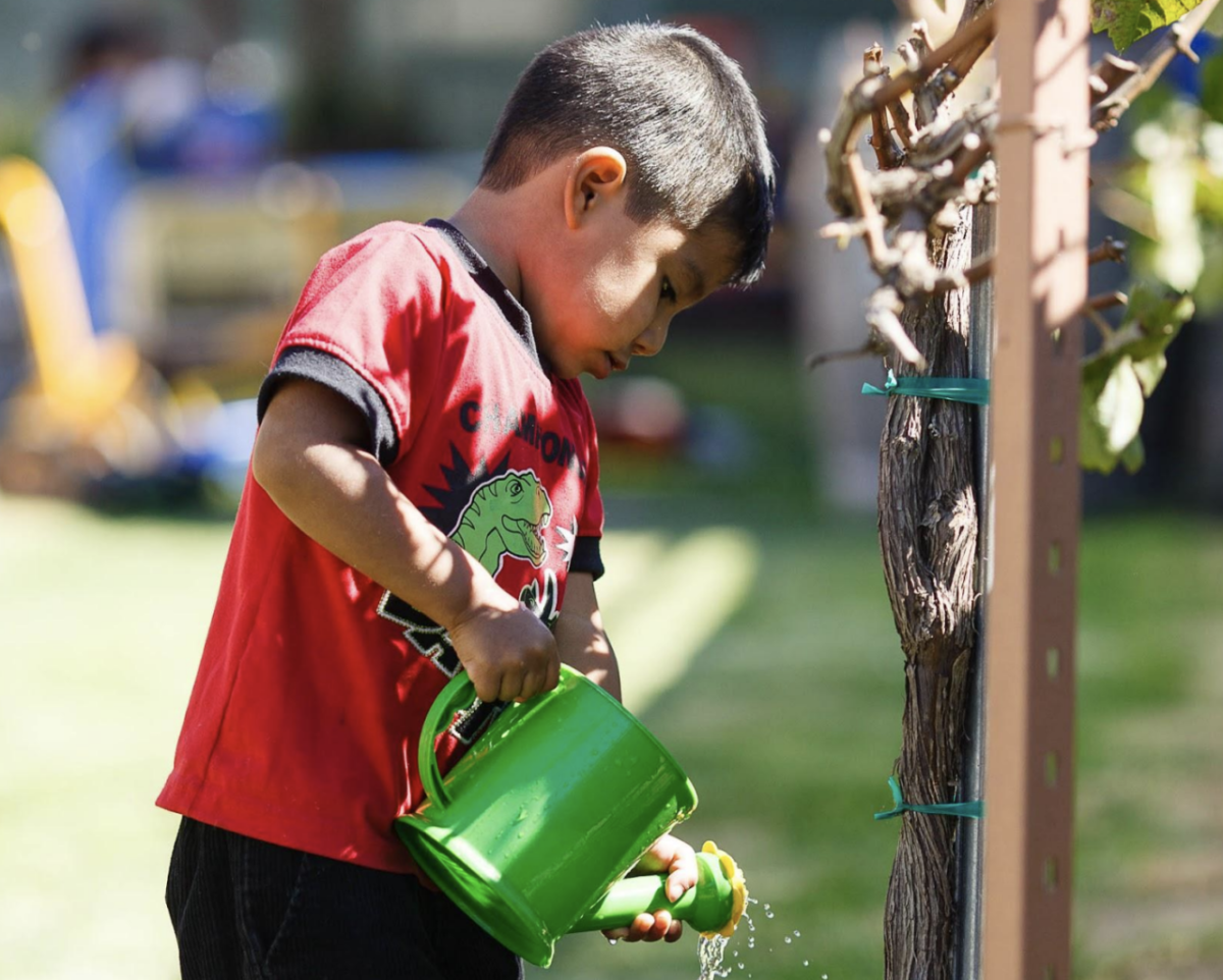 child with watering can