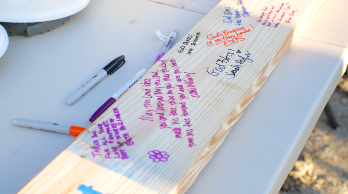 a piece of wood with notes and messages written on it