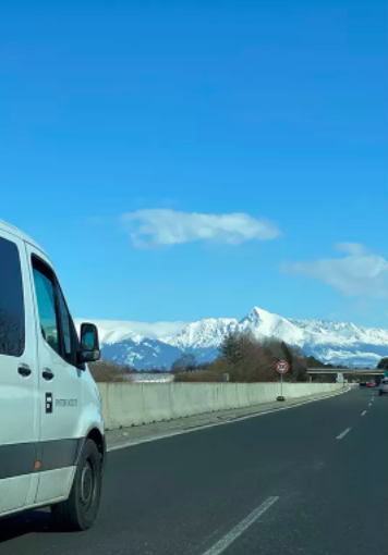 A van transporting refugees to safety in the Czech Republic travels through Slovakia, with the High Tatras Mountains in the distance