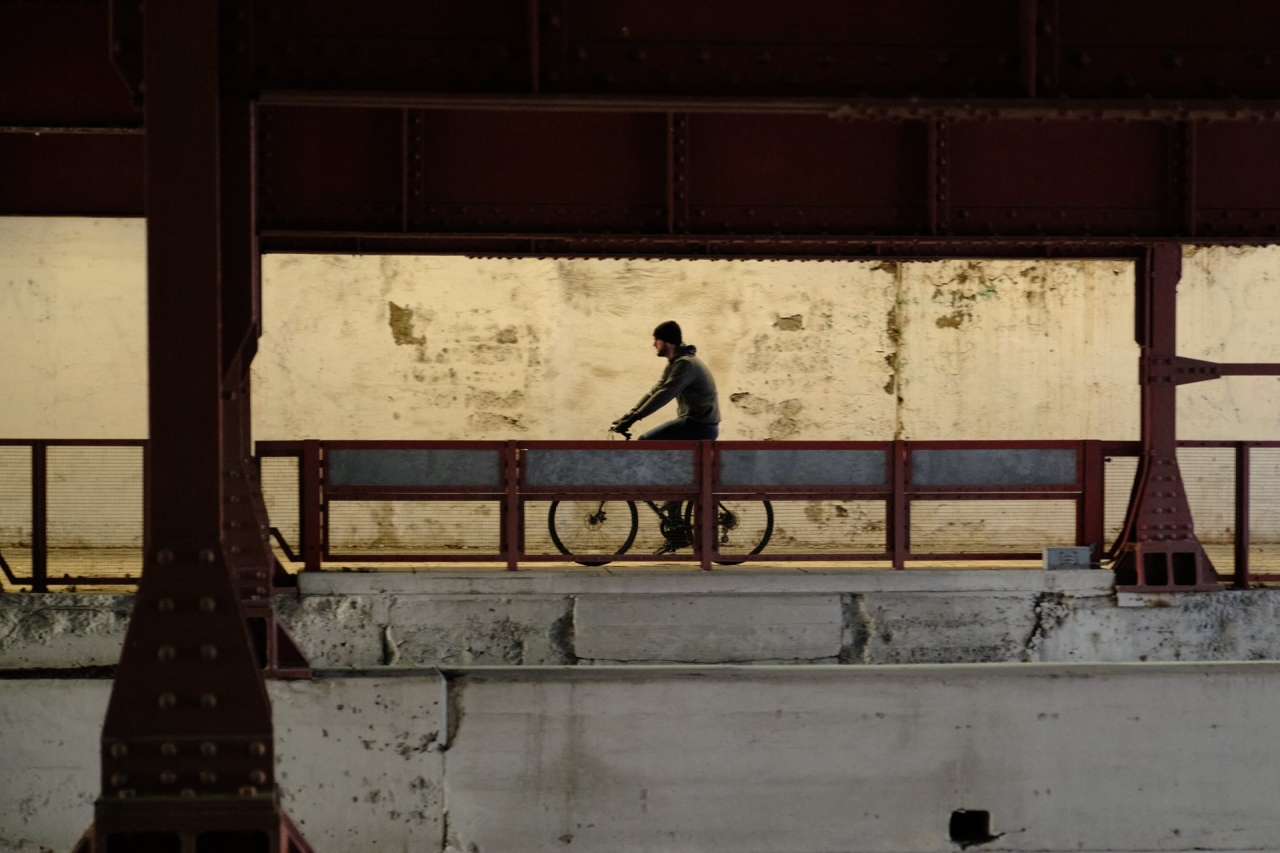 Richard McMichael riding a bike in an industrial landscape