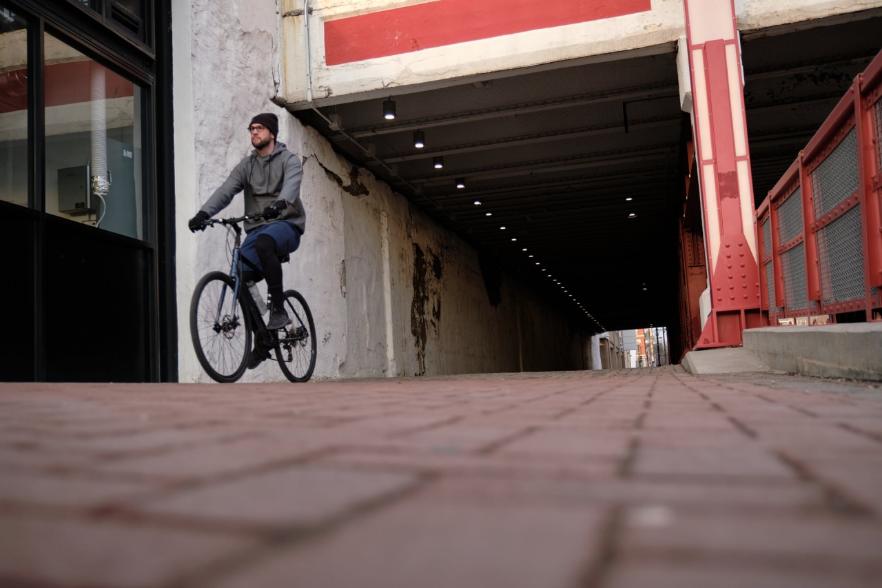Richard McMichael riding his bike through a city