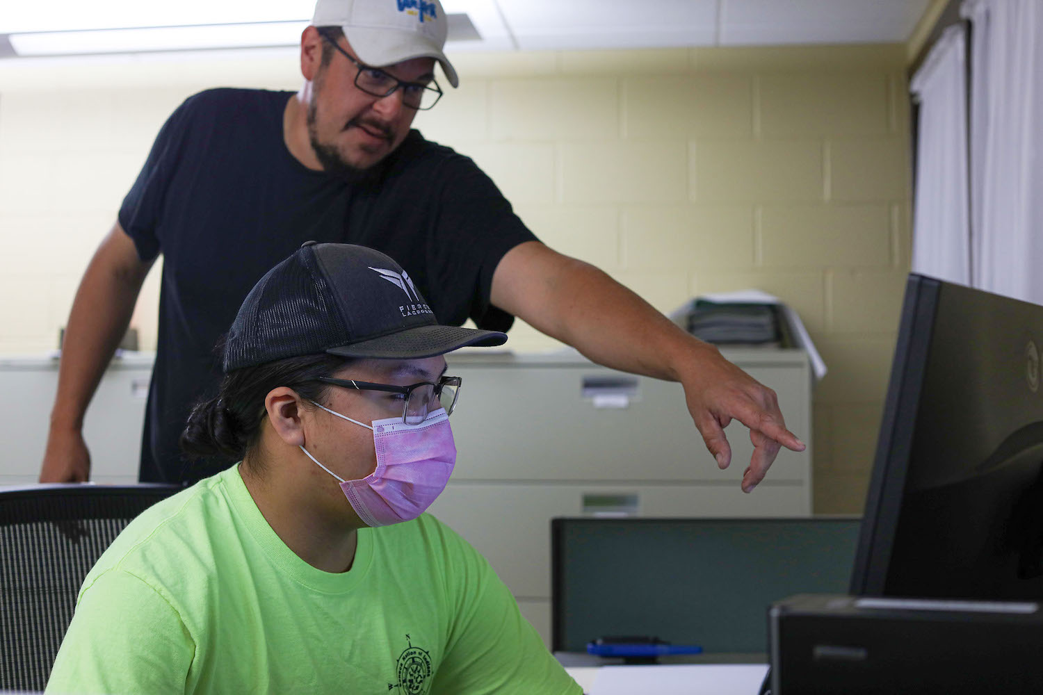 Seneca Nation workers learning on computer - tribally-owned business operations fund Native Nations