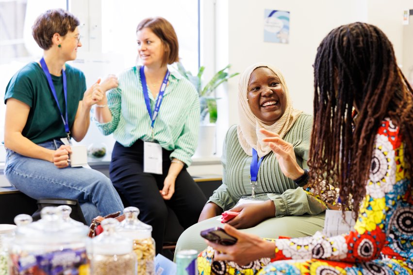 Jamila Mayanja speaks with other attendees of the American Express Leadership Academy.