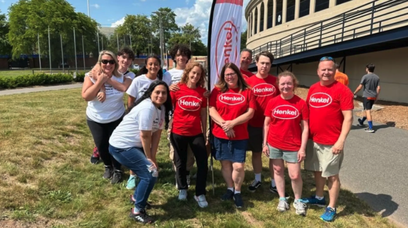 People standing on lawn in Henkel t-shirts