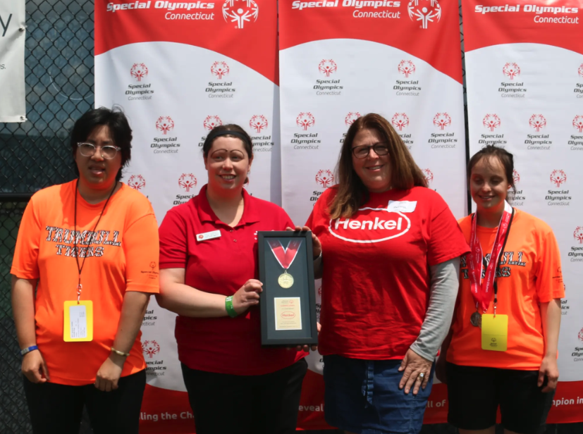 People standing with award