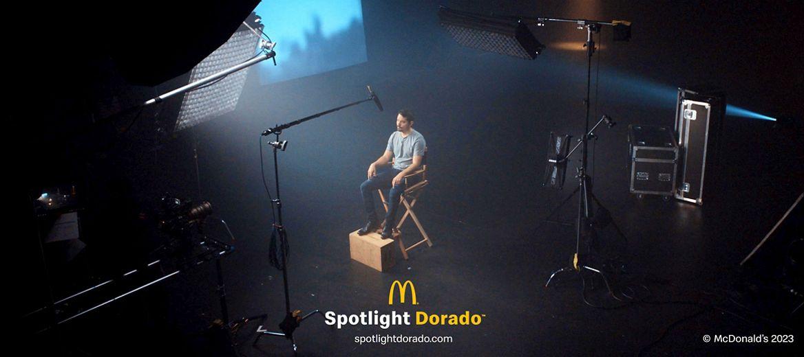 Person sat on a film set under a spotlight