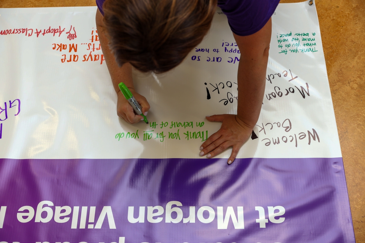 person writing on a sign