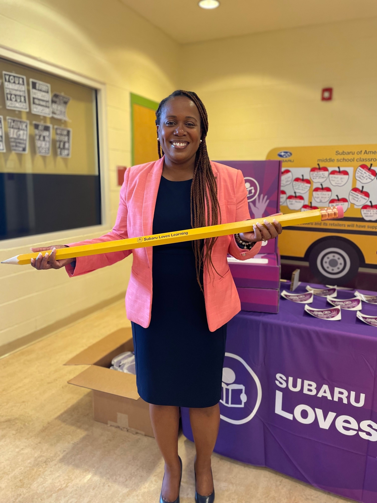 person holding an oversized pencil