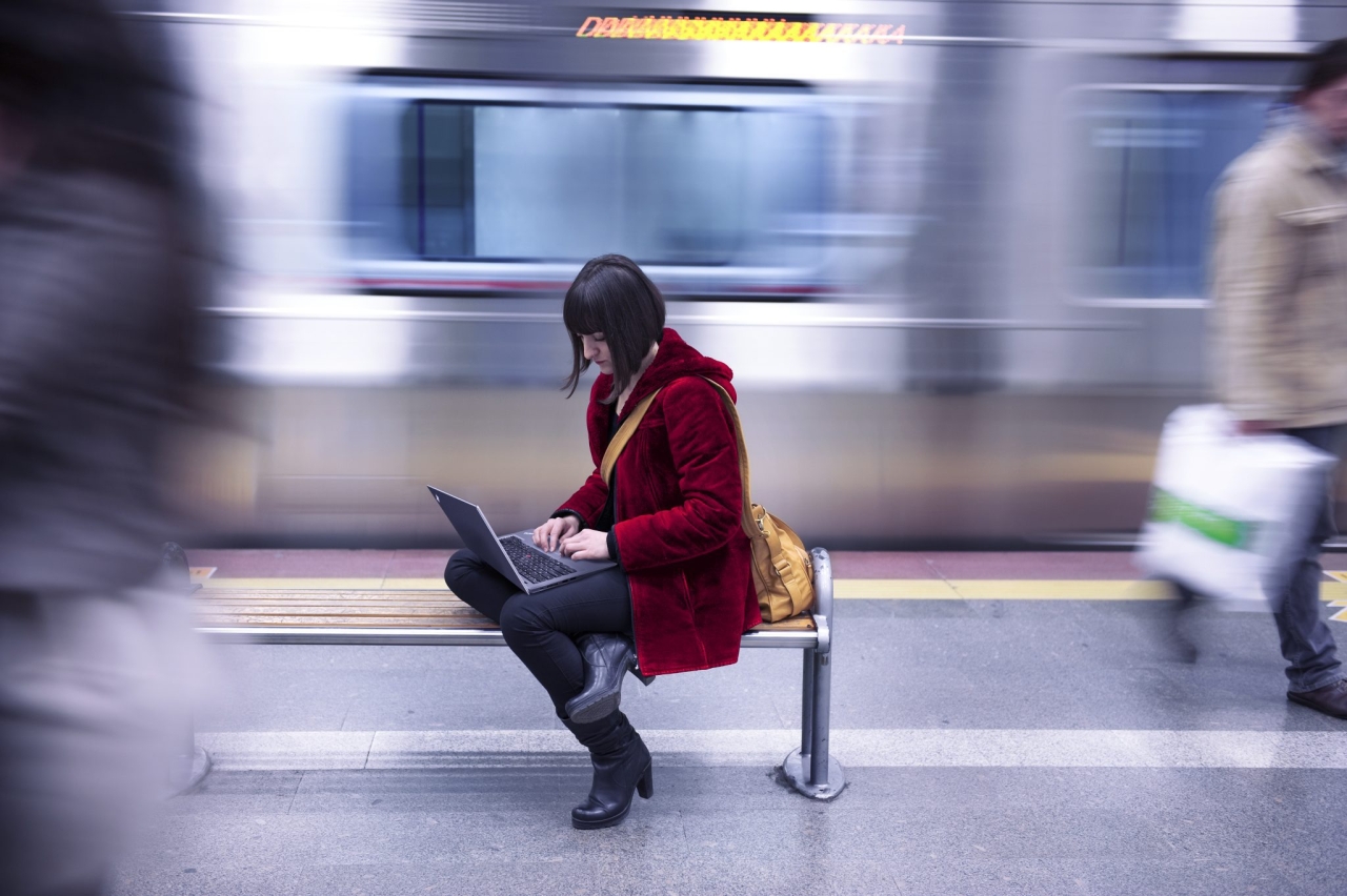 a person in a subway station working on a laptop