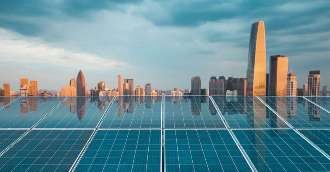 Solar panels shown on top of a building in a city.