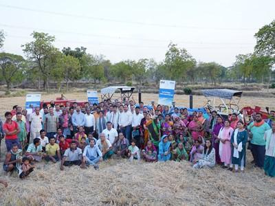 Large group standing and sitting together outside