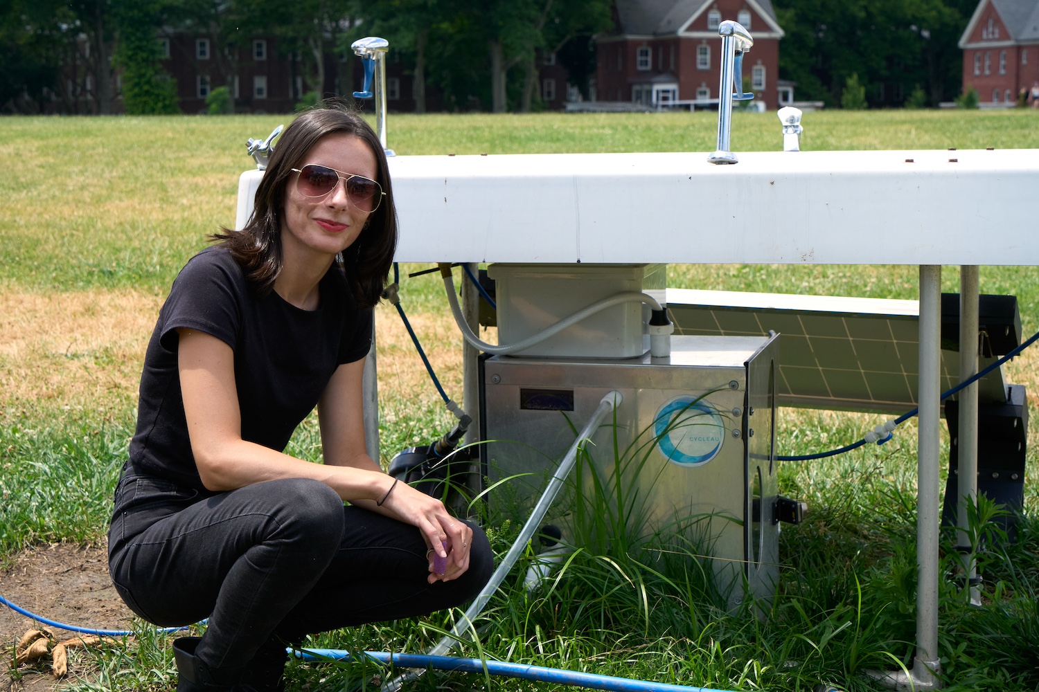 Noemi Florea sits next to her greywater recycling system — Swarovski Foundation