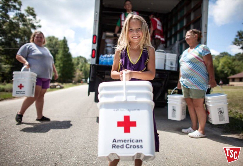volunteers carry Red Cross buckets