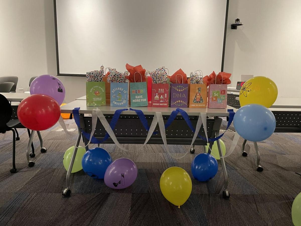 table full of activity kit bags with balloons