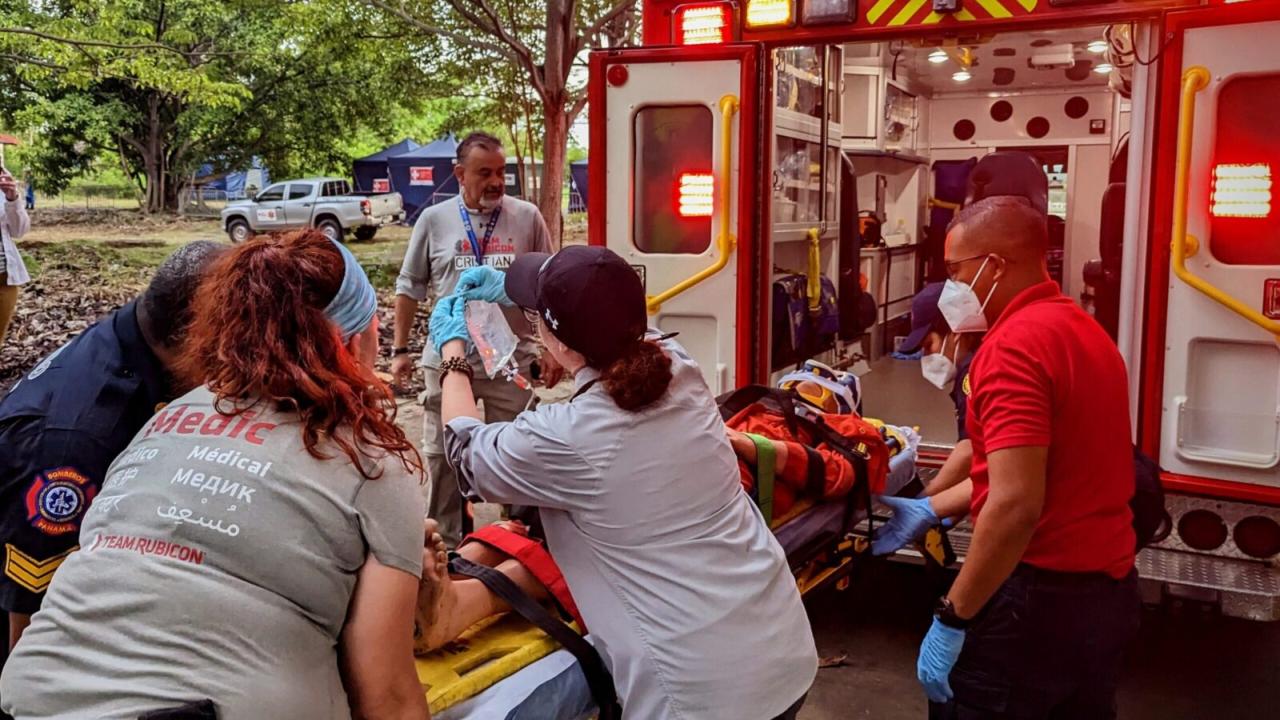 Emergency personnel loading a patient into an ambulance