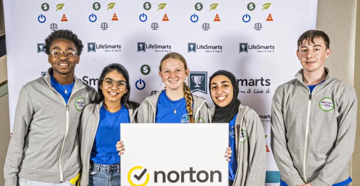 A team of five students holding a Norton sign.