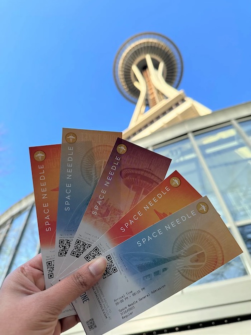 Thelma Gomes holding tickets for the Space Needle.