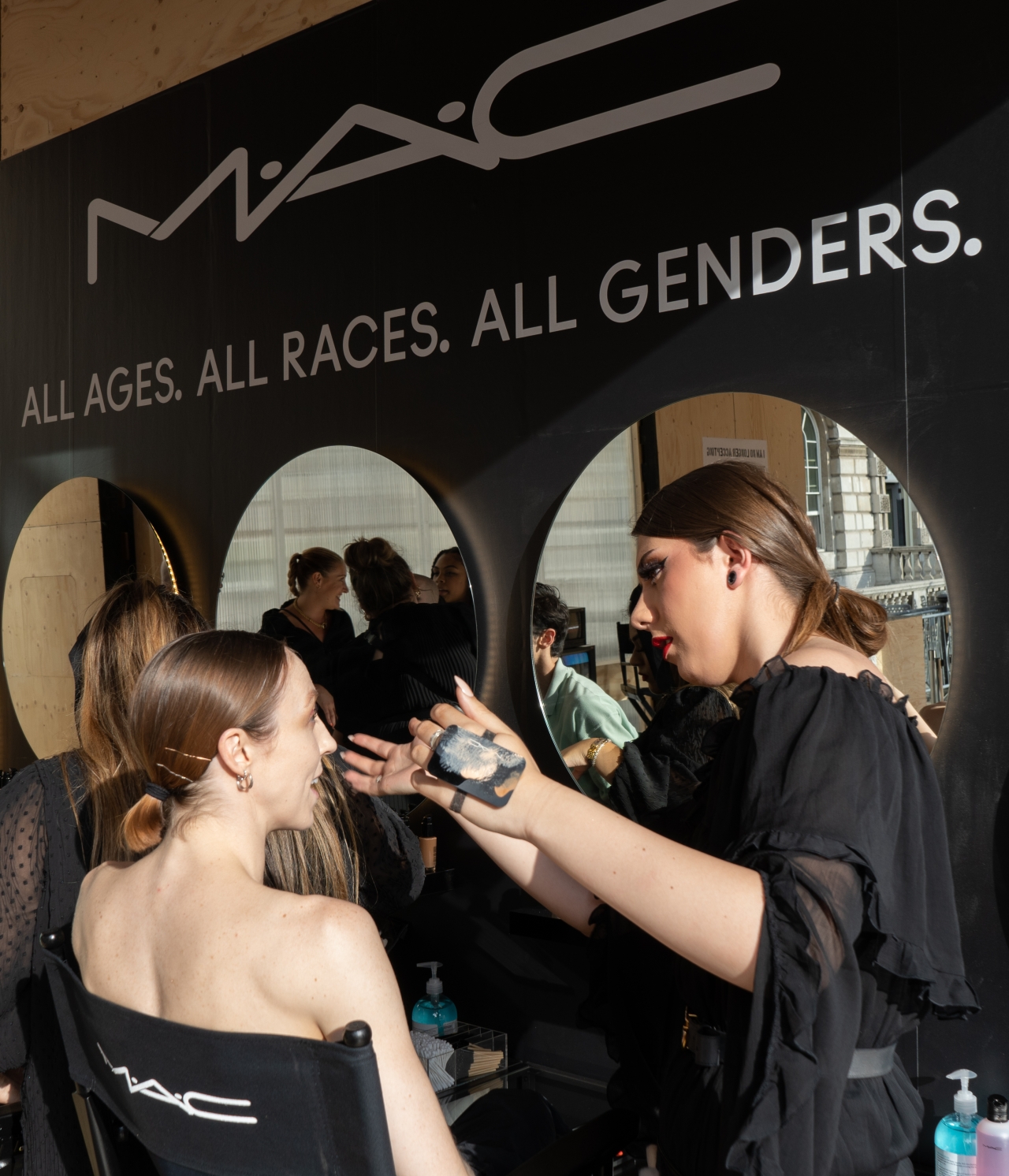 makeup artist working with a model