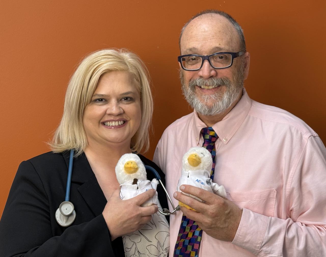 Tom and Tricia shown holding Aflac Ducks.