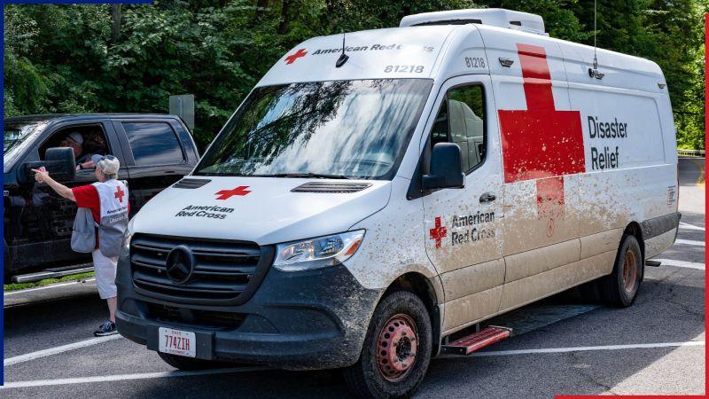 Red Cross relief van shown helping a stranded vehicle.