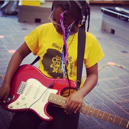 Child with an electric guitar