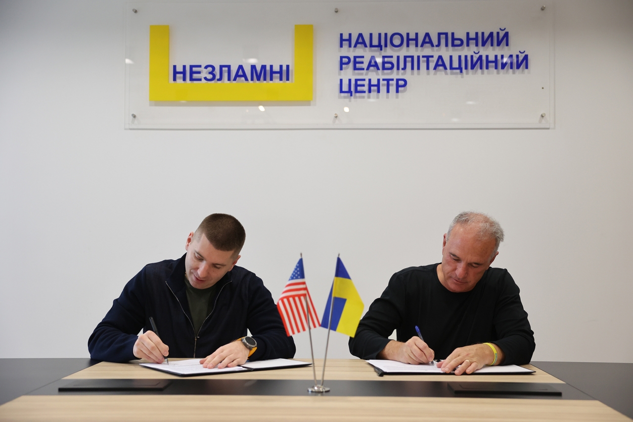2 people signing documents