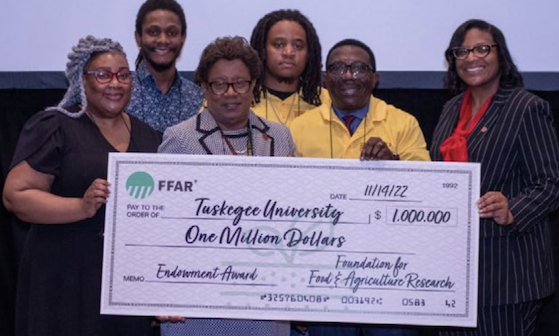 People holding a cheque for Tuskegee University 