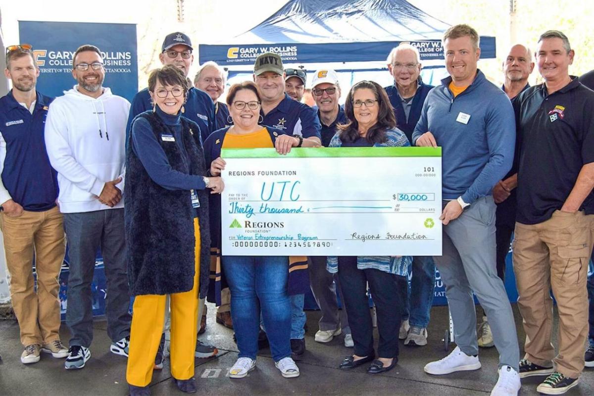 Group of people holding a cheque  