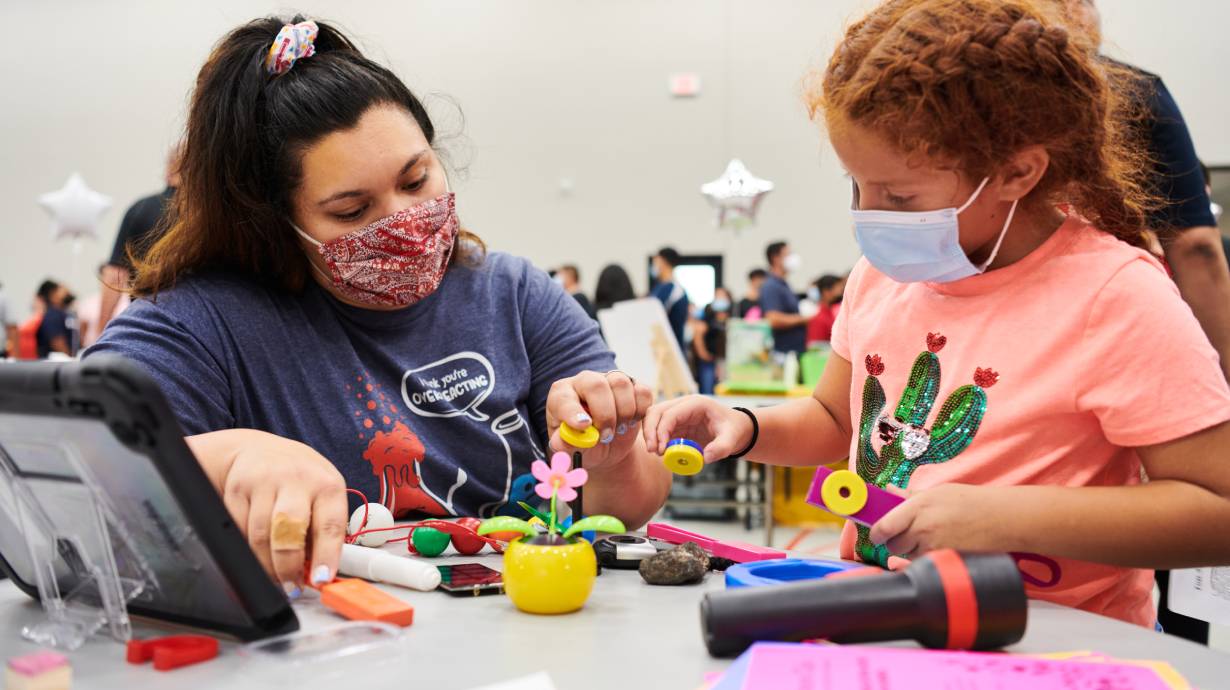 Eighth grade science teacher GabrielaTorres and student Sophia C. experiment with magnets at the rollout event. Credit: Saeed Rahbaran