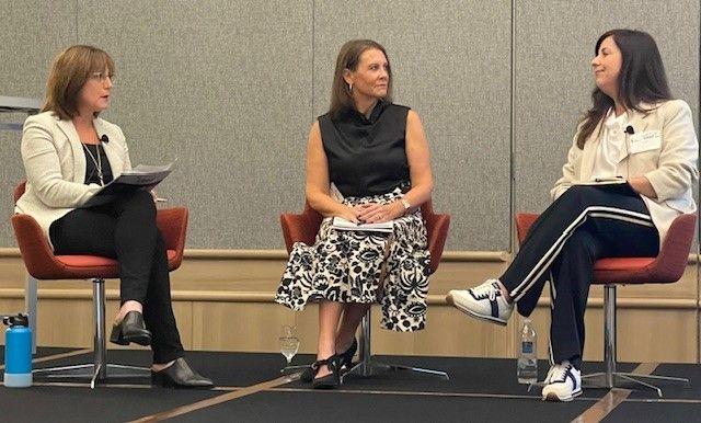 Three people sitting on chairs looking at each other