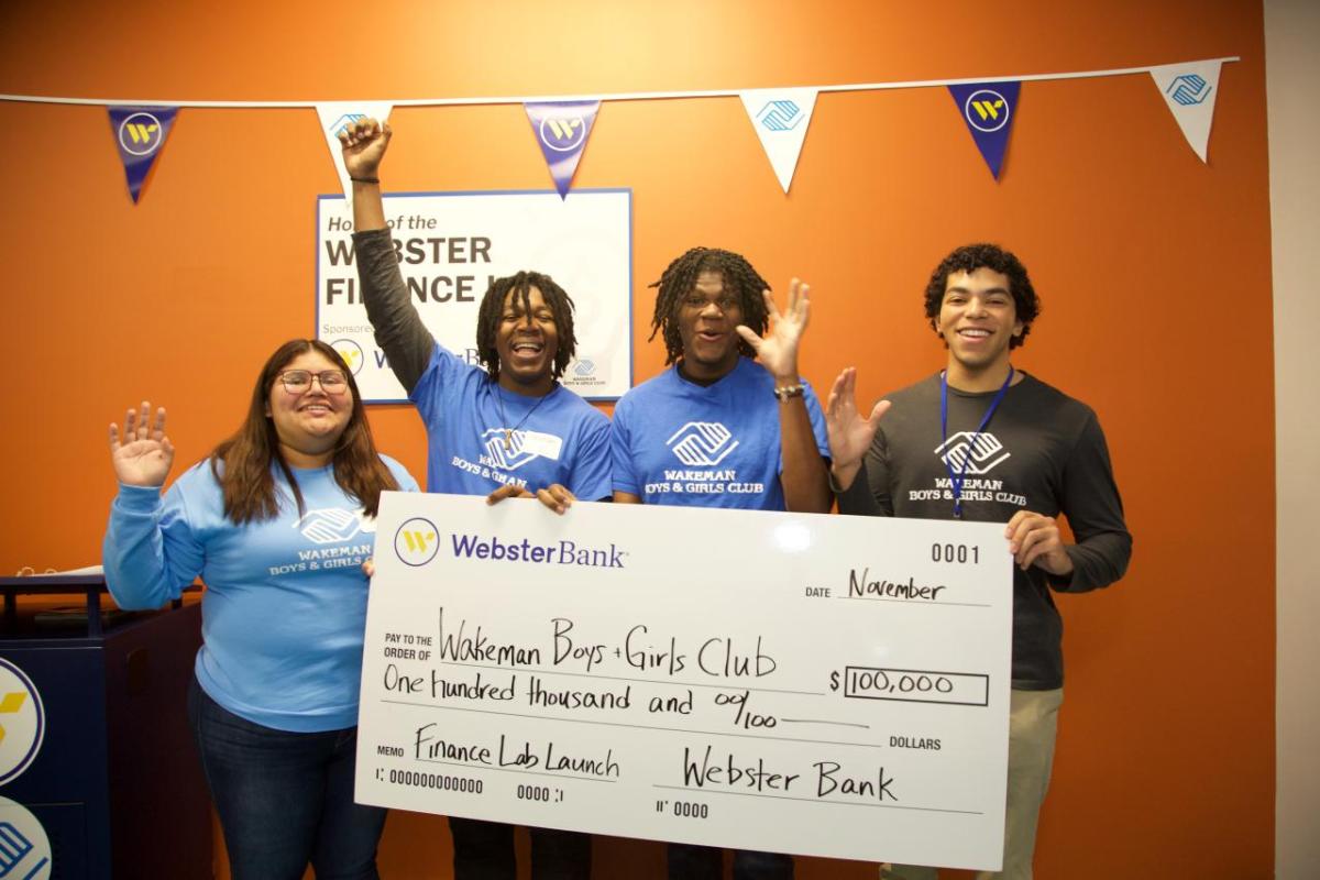 Group celebrating with oversized check