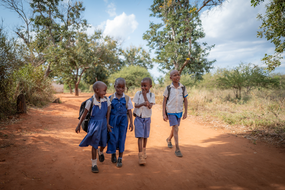 Four school children walking together