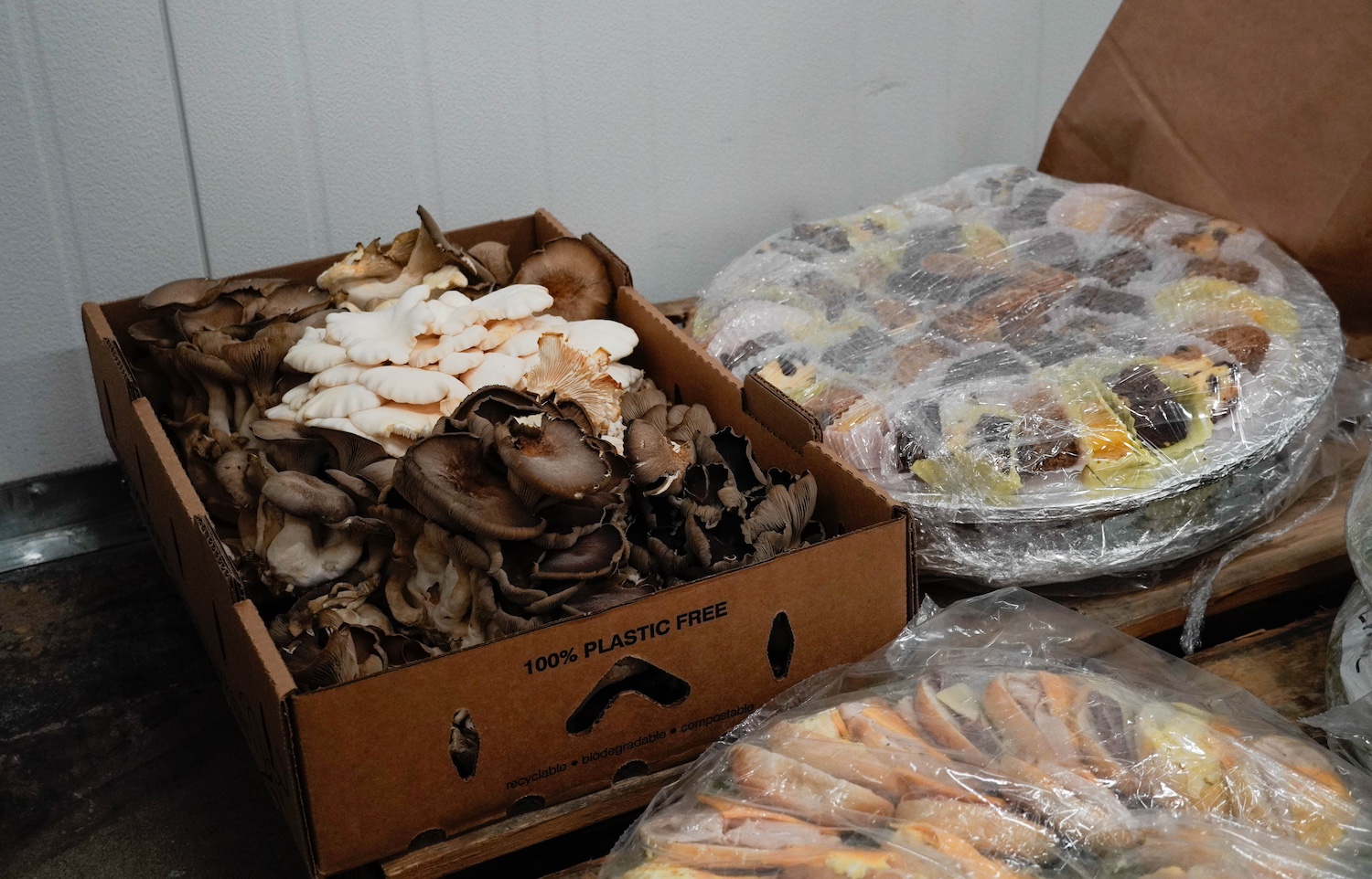 A box of mushrooms sits in cold storage at the We Don't Waste facility — food waste