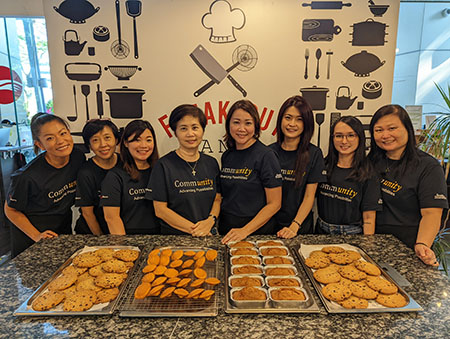 group with trays of freshly baked cookies