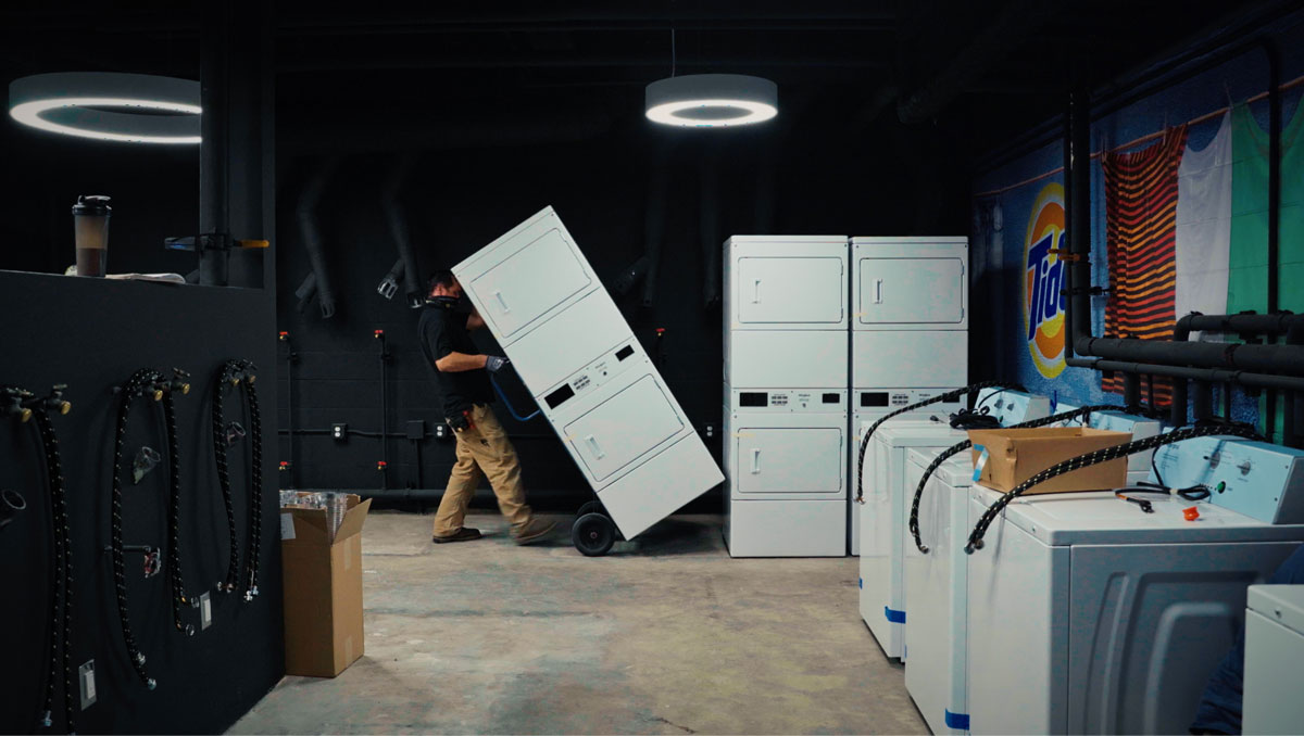 Person loading washing machines in a warehouse