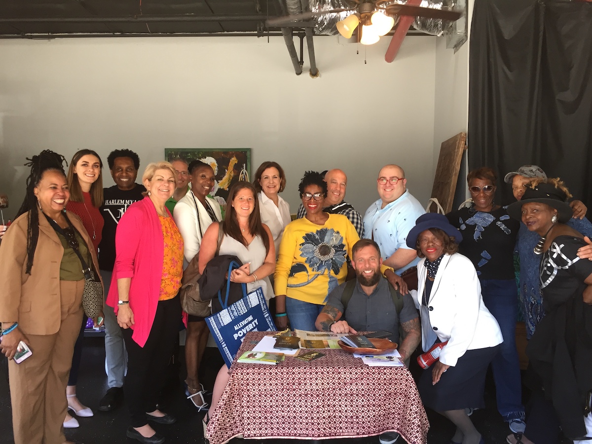 Tropicana Brands Group Philip Coughlin (center, back row) with fellow donors meeting microcredits client on a Whole Planet Foundation Impact Visit in Harlem.