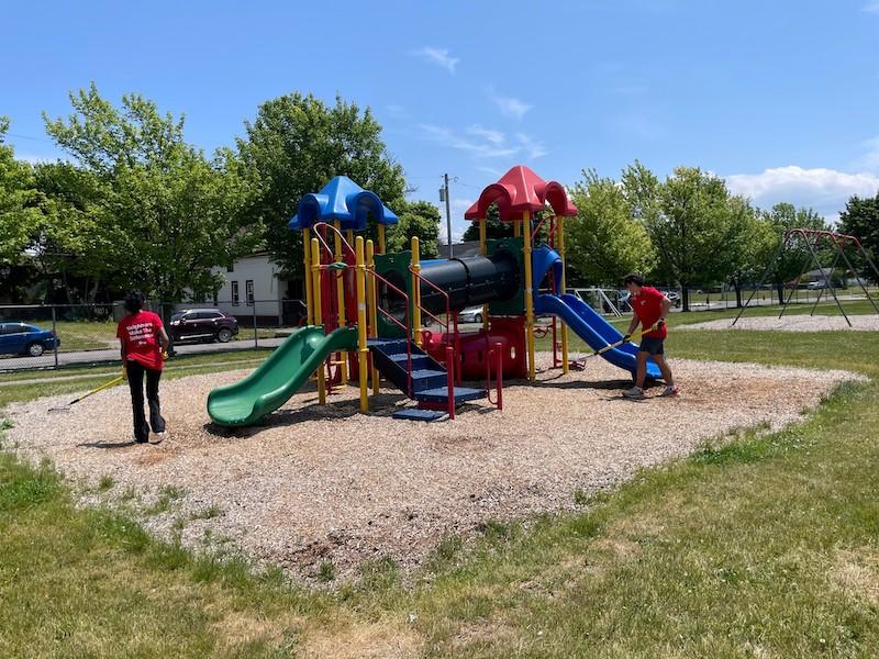 KeyBank volunteers cleaning up a playground.