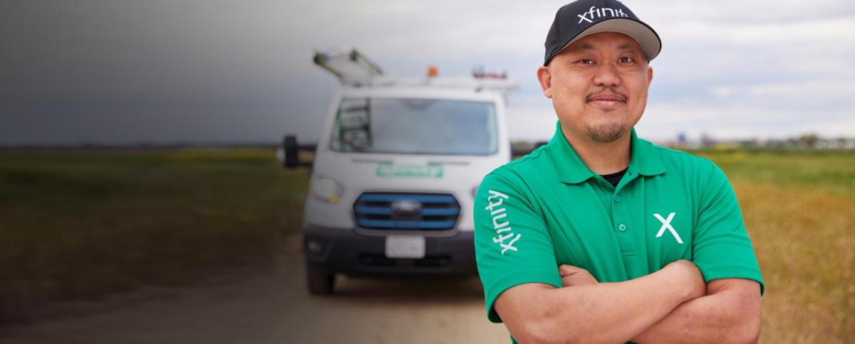 Person wearing a Xfinity t-shirt stood in front of a van