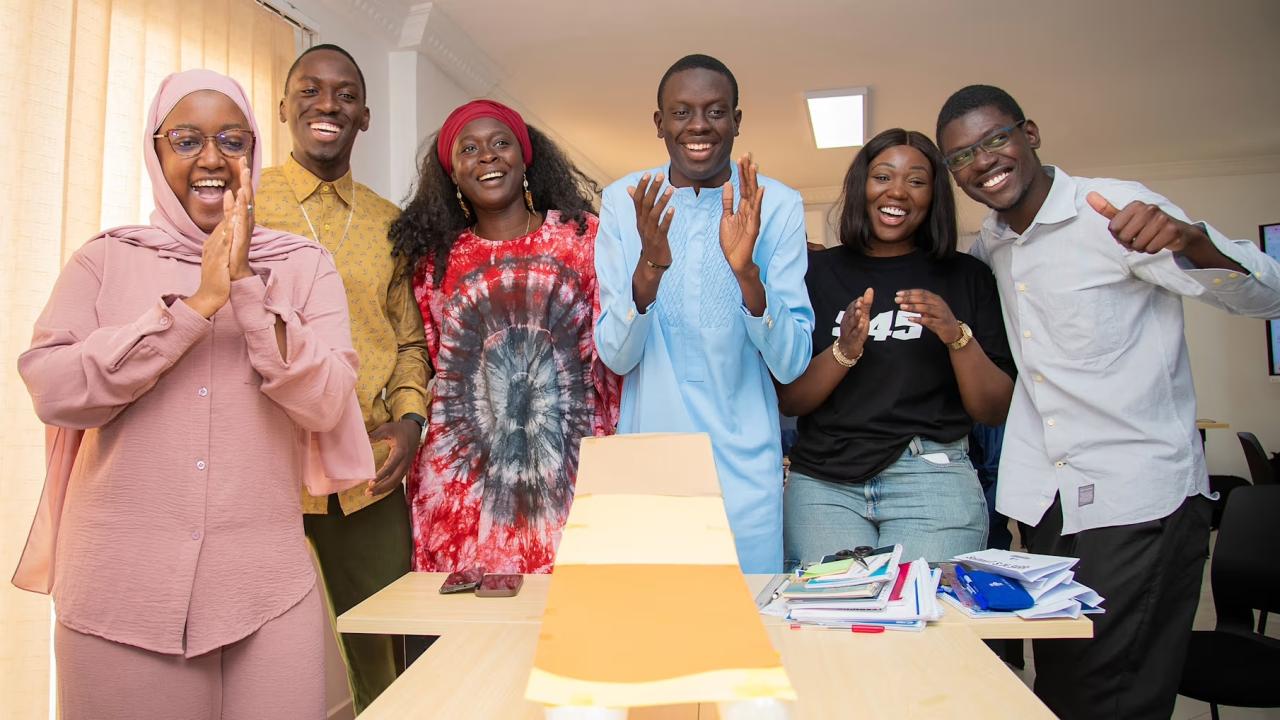 Group of young people clapping and smiling 