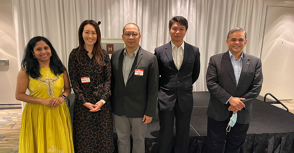 5 AAPI Dow employees, wearing suits and dresses, standing in a row