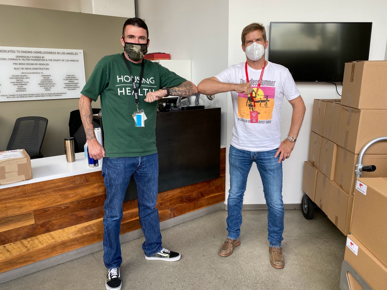 two people posing with facemasks on