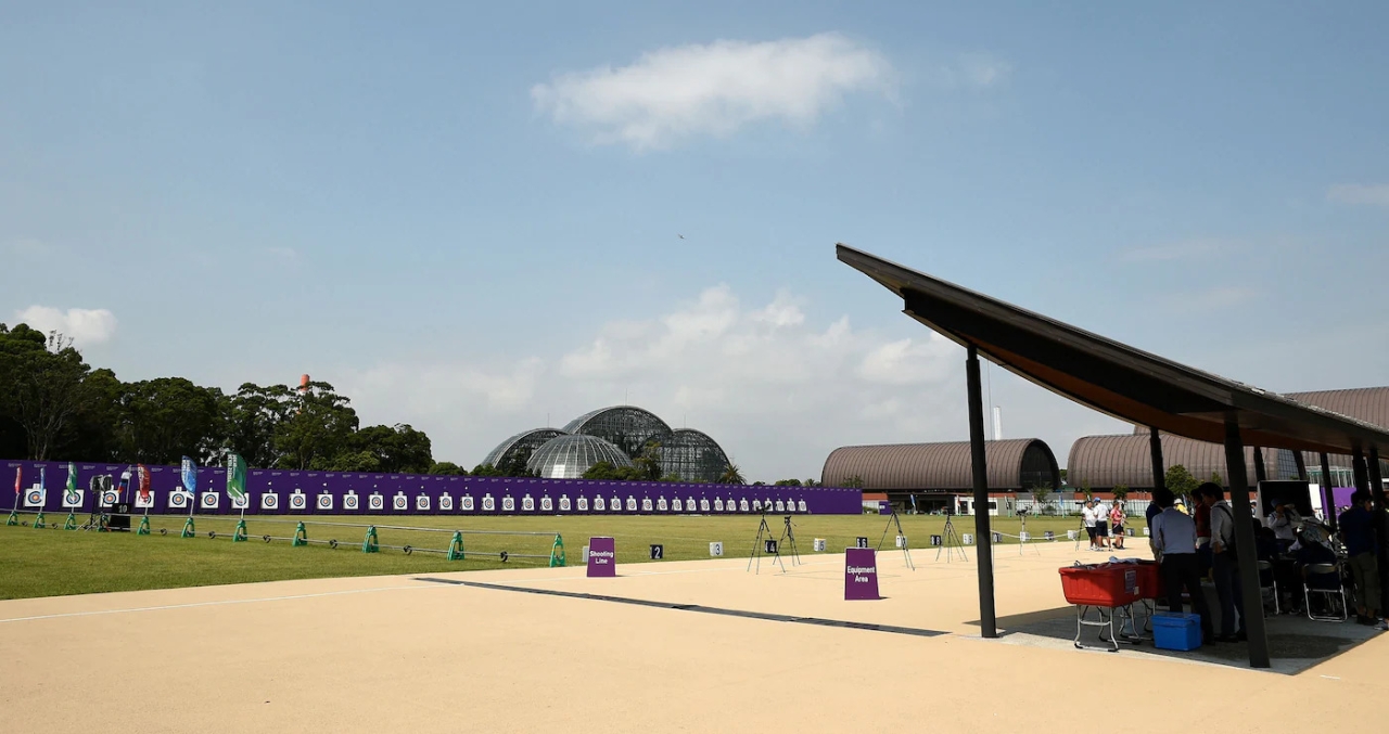 a long archery range and covered shelter. A domed building in the background