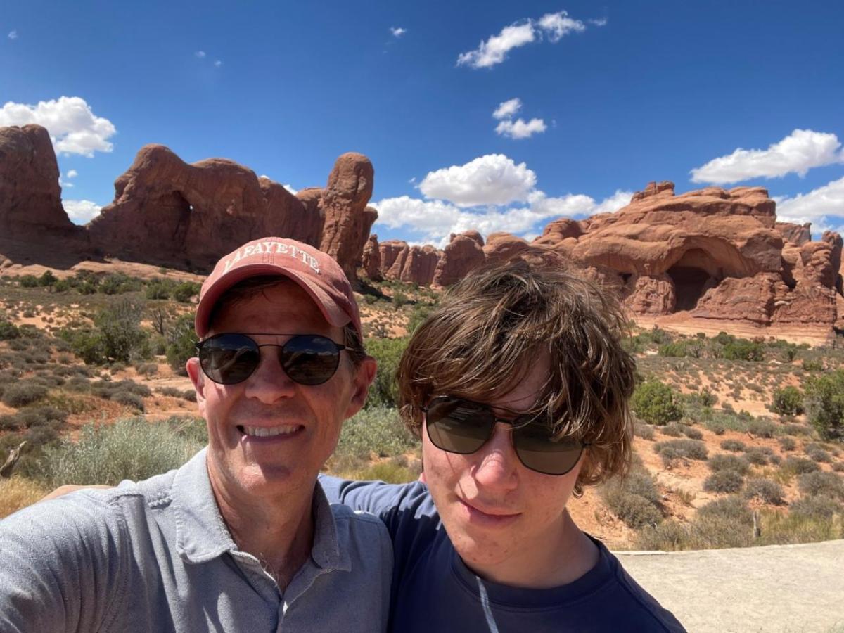 John Mulcahy and family member posed in a scenic natural area.